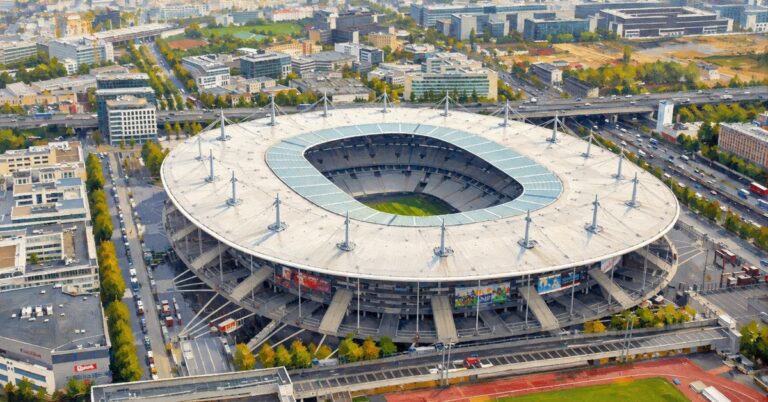 Refined editorial oil painting of Stade de France in Saint-Denis, showing its oval roof and surrounding city from above.